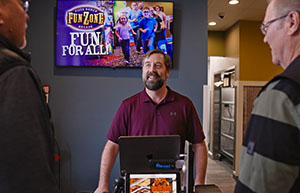 Pizza Ranch Employee taking customer order at counter